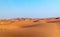 Arabian desert dune background on blue sky