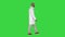 Arabian doctor in white robe walking on a green screen, chroma key.