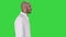 Arabian doctor in white robe walking on a Green Screen, Chroma Key.