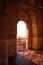 Arabian doors, with details on hand-carved walls and the sun entering through the door. Mosaic walls