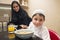 Arabian family of mom and son having breakfast in the kitchen
