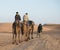 The arabian guide with couple of tourist in Sahara desert