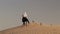 Arabian horse rider riding on desert in Dubai