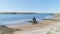 Arabian horse rider walks from desert to lake