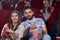 Arabian man and caucasian woman eating popcorn at cinema.