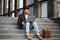 Arabian man sitting on stairs and working on laptop