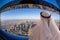 Arabian man watching cityscape of Dubai with modern futuristic architecture in United Arab Emirates.