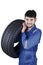 Arabian mechanic lifting car tyre