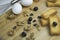 Arabian Mediterranean food ingredient egg, teac, rusk biscuit, black olives, walnut, zaatar, thyme, raisins on wooden platter