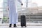 Arabian men standing in the city and holding luggage ready to journey