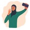 Arabian muslim blogger making photo selfie for blog or vlog review. Cute brunette girl  with smartphone camera. Golden earrings,