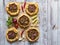 Arabian opened meat pies on white wood background.