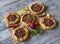 Arabian opened meat pies on white wood background.