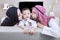 Arabian parents kiss their son at home
