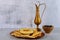 Arabian party table with hummus, bread and copper jug