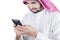 Arabian person reads message on smartphone