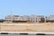 Arabian rectangular houses in the desert with windows against the background of yellow sand and blue sky in Egypt and black and wh