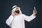 Arabian saudi man on dark blue studio background