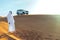 Arabian sheikh in long white dress closeup in the middle of Dubai desert