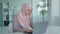 Arabian worker user Islamic businesswoman Muslim in hijab in office sitting table looking laptop screen reading bad news