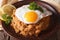Arabic Breakfast: ful medames with a fried egg close-up. horizon