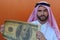 Arabic businessman showing a gigantic 100 dollars bill