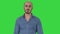 Arabic casual man walking and talking to camera on a Green Screen, Chroma Key.