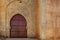 Arabic door Bab laalou in the wall of the medina of Rabat in Morocco. Reddish varnished wood