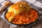 Arabic food: kabsa with chicken and almonds close-up on a plate.