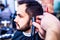 arabic handsome bearded man getting haircut at barbershop