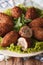 Arabic kibbeh with bulgur and pine nuts on a plate macro. vertical