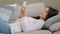 Arabic latino restful lazy young woman lebanese girl freelancer lying on sofa at home relaxing reading sms message on