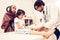 Arabic Male Doctor Bandaging Limb of Child Patient