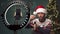 Arabic male influencer wearing Santa hat recording video blog about unboxing of new smart watch. Blogger doing review of
