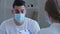 Arabic man hispanic guy patient sick male wears medical protective mask on face talks about symptoms of health problems