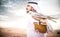 Arabic man with traditional emirates clothes walking in the desert with his falcon bird