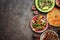 Arabic and Middle Eastern dinner table, meat kebab,tabbouleh salad, Fattoush salad,pita on a dark rustic background. Top view,