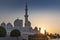 Arabic mosque facade with domes, with sunset light. Great Mosque. UAE. Abu dhabi