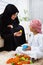 Arabic mother and son together at home playing with toys.