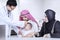 Arabic parents and doctor checkup their baby