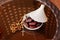 Arabic rosaries and dates on a white plate with a lid on a glass table. The Islamic Holy month of Ramadan