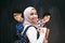 Arabic teenagers, students group portrait against black chalkboard wearing backpack and books in school.Selective focus