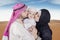 Arabic young couple kiss their son