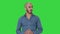 Arabic young man in shirt talking presenting something and pointing to the side on a green screen, chroma key.