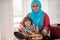 Arabic young woman with little kid in kitchen