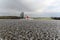 Arable crop field with chapel in background, winter season landscape