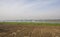 Arable ploughed farm fields on edge of large river