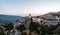 Arachova Greece mountain town aerial drone view. Traditional houses in the evening