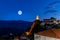 Arachova village in Greece against the full moon.