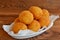 Arancini balls on a plate. Fried rice balls recipe. Rice cutlets. Brown wooden background
